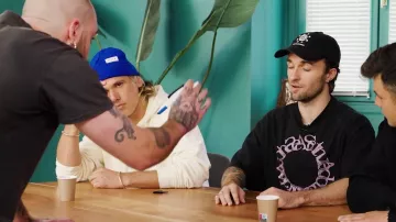 The black Acne Studios t-shirt worn by Squeezie in the YouTube video Who's the Impostor? #4 feat. Orelsan & Clément Cotentin