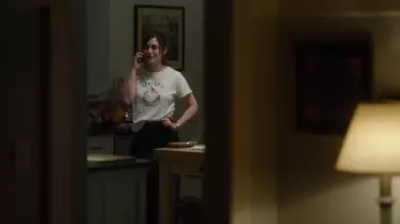 Apollo 11 T-shirt in white worn by Libby Epstein (Lizzy Caplan) as seen in Fleishman Is in Trouble Wardrobe (S01E08)