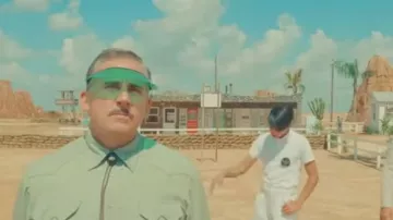 Green visor capt worn by Steve Carell as seen in Asteroid City movie