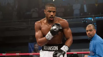 The black Grant boxing gloves worn by Adonis Johnson (Michael B. Jordan) in the movie Creed: The Legacy of Rocky Balboa