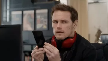 Red headset worn by Rob Burns (Sam Heughan) as seen in Love Again