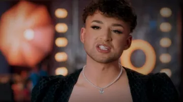 Flatfoosie Heart An­gel Neck­lace worn by Charlie Carter as seen in Glow Up: Britain's Next Make-Up Star (S04E01)