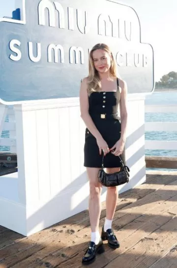 Miu Miu Grain De Poudre Mi­ni-Dress worn by Brie Larson at  Miu Miu Summer Club Beach Party post on July 26, 2023