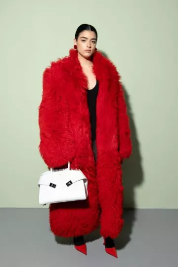 Ferragamo Shearling Long Length Coat worn by Dixie D'Amelio at Ferragamo Fashion Show on September 23, 2023