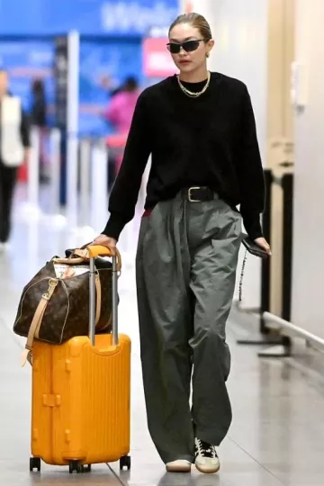 Rimowa Essential Cabin Suitcase in Mango worn by Jelena Noura "Gigi" Hadid in New York City on September 23, 2023