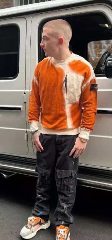 Stone Island Or­ange Spray Dyed Sweat­shirt worn by ArrDee on his Instagram account @arrdeegram