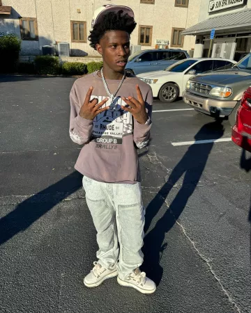 Amiri Bleached Indigo Allover Logo Carpenter Jeans worn by Quando Rondo on the Instagram account @quando_rondo