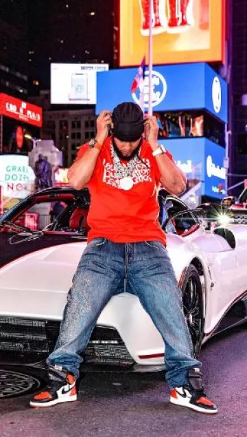 Givenchy Blue Faded Studded Logo Jeans worn by El Alfa on the Instagram account @elalfaeljefe