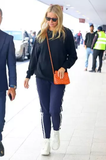 Goyard Plumet Pouch Orange worn by Gwyneth Paltrow at Sydney Airport on  October 28, 2023