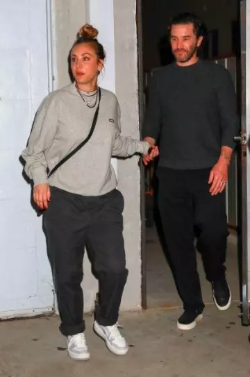 Nike Air Jordan 1 Low University Sneakers worn by Kaley Cuoco and Tom Pelphrey Arrives Churchome Service at Saban Theater on October 25, 2023