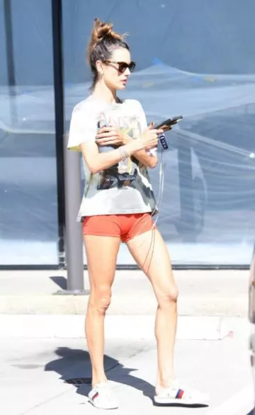 Gucci Ace Collapsible Heel Sneakers With Bees and Stars worn by Alessandra Ambrosio in  Malibu on October 5, 2023