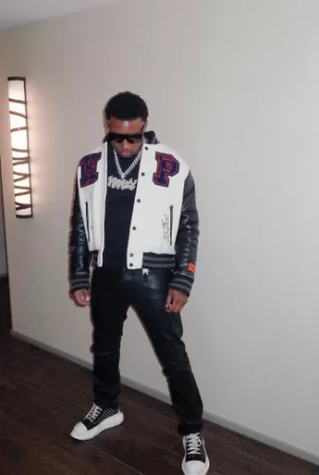 Heron Preston Ivory Alien Patch Varsity Jacket porté par Rob49 sur le compte Instagram @rob49up