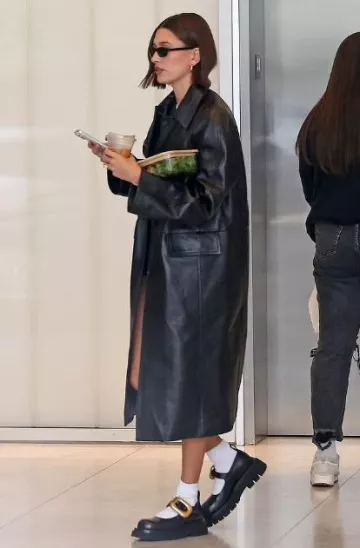 Saint Laurent 557 Sunglasses In Black worn by Hailey Bieber in Los Angeles on November 13, 2023