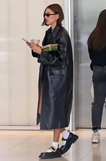 Saint Laurent 557 Sunglasses In Black worn by Hailey Bieber in Los Angeles on November 13, 2023