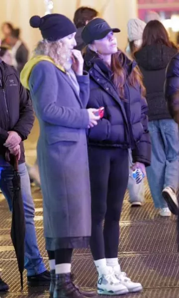 Jordan Mid­night Navy Sneak­ers worn by Victoria Beckham at Winter Wonderland in London’s Hyde Park post on November 18, 2023