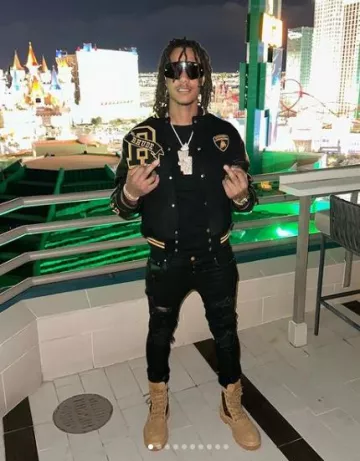 Rhude Rhude x Lamborghini Black R-Patch Varsity Jacket worn by Skilla Baby on the Instagram account @_skillababy