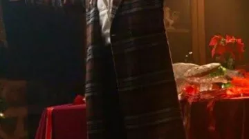 Abrigo a cuadros usado por Avery (Italia Ricci) como se ve en la película Atrápame si Claus