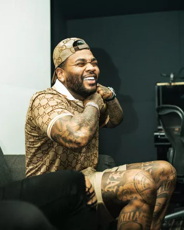 Gucci Beige-GG & Orange Trim Polo worn by Kevin Gates on the Instagram account @iamkevingates