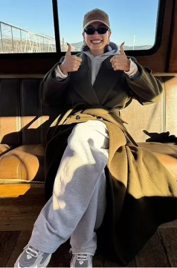 Saint Laurent Long Belted Wool Coat worn by  Hailey Bieber on her Instagram Post on December 1, 2023