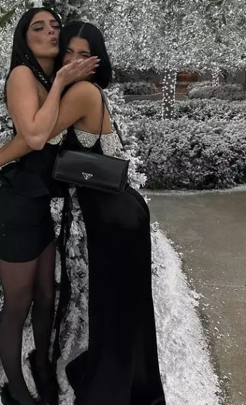 Prada Brushed Leather Femme Bag worn by Charli D’Amelio at Kardashian-Jenner Annual Christmas Eve Party on December 24, 2023