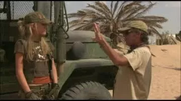 Olive green "Diesel" zip vest, brown "Giddy Up or Go Home" t-shirt, olive green skirt and orange tank top worn by K-Mart (Spencer Locke) as seen in Resident Evil: Extinction