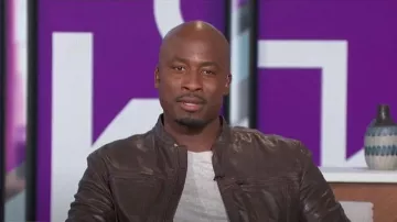 John Varvatos Leather Band Collar Moto Jacket worn by Akbar Gbaja-Biamila as seen in The Talk on January 24, 2024