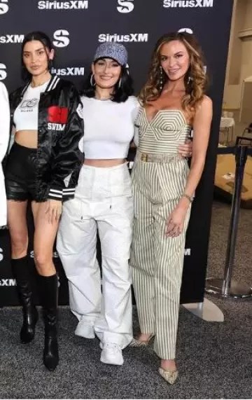 Darkpark Rhinestone-Embellished Cotton Palazzo Trousers worn by Nikki Bella at Sirius Xm Super Bowl Special on February 9, 2024