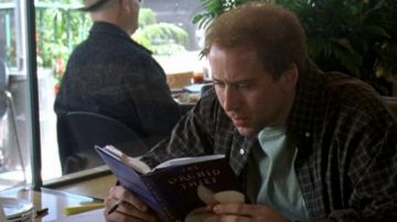 The French version of the book that reads: Charlie Kaufman (Nicolas Cage) in Adaptation.