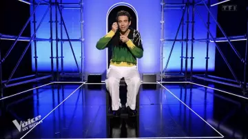 The green and black knit Prada sweater worn by Mika on The Voice: The Battles on April 6, 2024
