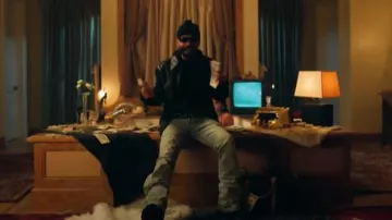 Amiri Clay Indigo Flared 'Stack' Jeans worn by Arcángel in PESO COMPLETO (Video Oficial) - Peso Pluma, Arcángel