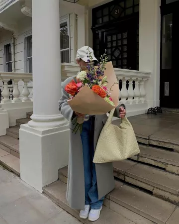 Celine Triomphe Baseball Cap in Cotton Vanilla worn by Leonie Hanne on her Instagram Story on April 27, 2024