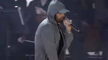 Eminem Outfits: he is wearing Grey Hoody Jacket for his Houdini live performance in Detroit, Michigan