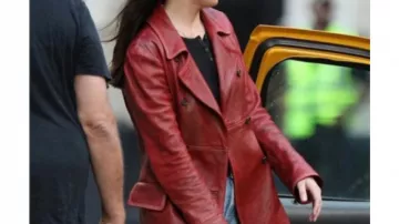Dakota Johnson Outfits: she is wearing Leather Peacoat in red to play Cassandra Webb on the set of Madame Web movie on October 12, 2022