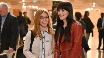 Dakota Johnson Outfits: she is wearing Leather Peacoat in red to play Cassandra Webb on the set of Madame Web movie on October 12, 2022