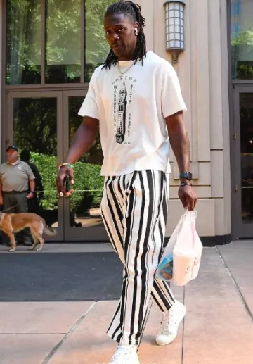 Dior White Oblique B23 High-Top Sneakers worn by Jrue Holiday on the Instagram account @nbafashionfits