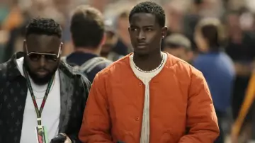 F1 Movie Outfits: Joshua Pearce (Damson Idris) is wearing Orange Quilted Jacket