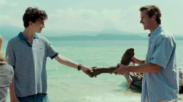 Call Me by Your Name Wardrobe: Elio (Timothée Chalamet) is wearing Striped Blue polo shirt by Lacoste