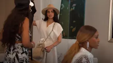 Themoirè Clori Top Handle Bag In Woven Straw worn by Sara Al Madani as seen in The Real Housewives of Dubai (S02E08)