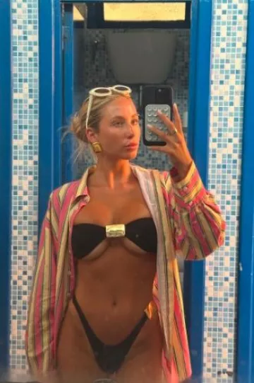 Frankies Bikinis Djerf Avenue Breezy Classic Shirt worn by Alix Earle on her Instagram Story on August 4, 2024