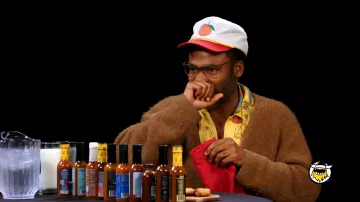 Donald Glover AKA Childish Gambino is wearing Peach Georgia Hat Cap in Hot Ones on July 2024