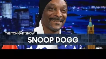 Snoop Dogg is wearing Team USA Olympics tracksuit at The Tonight Show Star­ring Jim­my Fal­lon on May 13, 2024