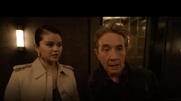 Outfits from Only Murders In The Building Season 4: Selena Gomez is wearing pleated long coat in beige in episode 2 to portray Mabel Mora in the TV series