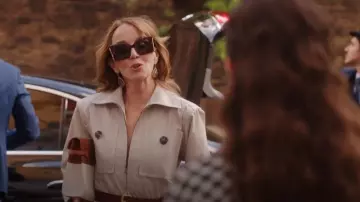 Saint Laurent Belted Cotton-Twill Jumpsuit In Beige worn by Sylvie Grateau (Philippine Leroy-Beaulieu) as seen in Emily in Paris (S04E09)