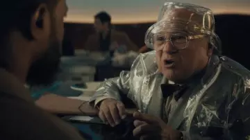 Outfits of Haunted Mansion: Danny DeVito wears Transparent Rain Hat to portray College History Professor