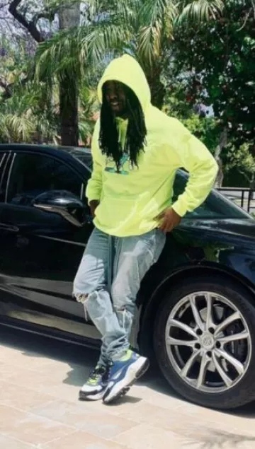 Dior Blue & Neon Yellow B22 Sneakers worn by Wale on the Instagram account @wale