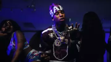 Bape Purple Big Logo Color Camo Beanie worn by NLE Choppa in NLE Choppa - Gang Baby (Official Music Video)