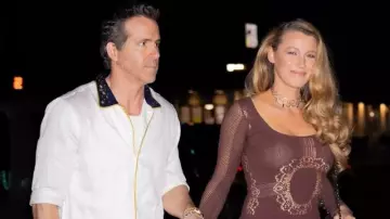 Ryan Reynolds wears white shirt with Navy collar on October 11, 2024 in New York City with Blake Lively