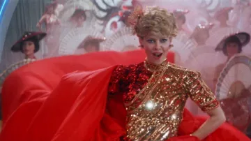 Indiana Jones and the Temple of Doom Wardrobe: Willie Scott (Kate Capshaw) wears Red and Gold Sequined High Neck Dress in the movie