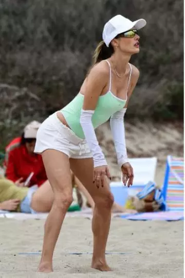 Alo Yoga Ivy League Bodysuit worn by Alessandra Ambrosio in Los Angeles Beach on October 6, 2024