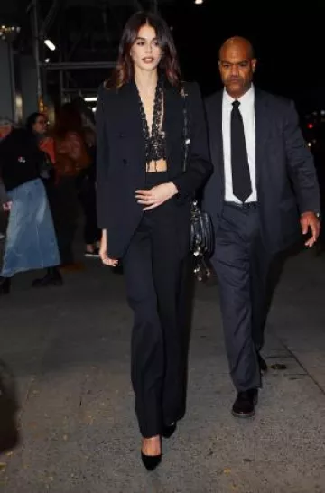 Chloe High-Rise Grain De Poudre Wool Wide-Leg Pants worn by Kaia Gerber at Saturday Night Screening on October 8, 2024